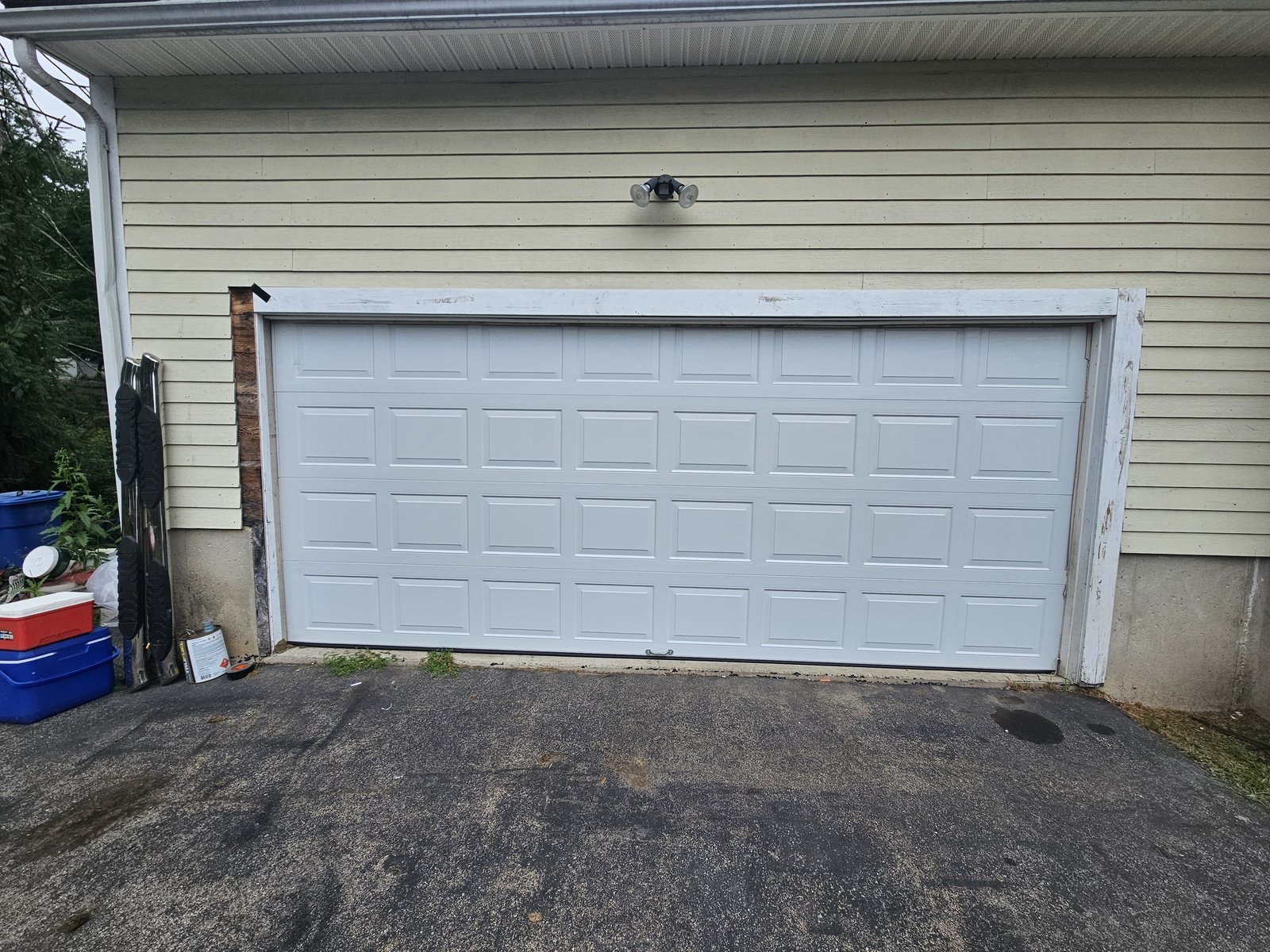 New white raised-panel garage door installed in the same opening, Methuen MA
