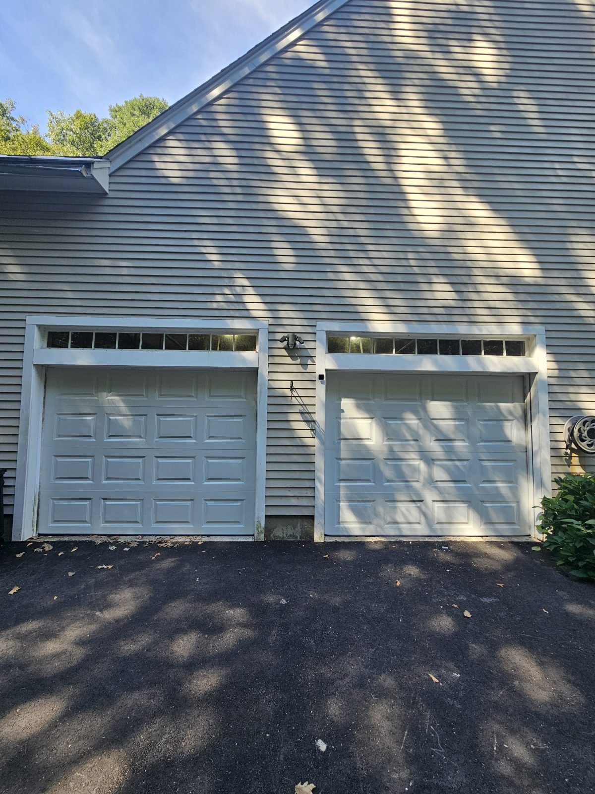 New white raised-panel garage door installed in the same opening