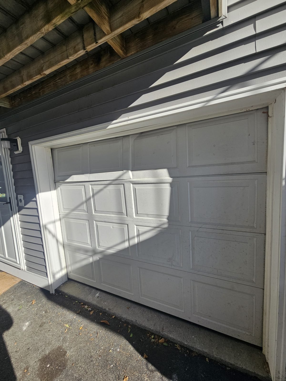 Garage door before replacement, door removed ahead of new installation in Lawrence area