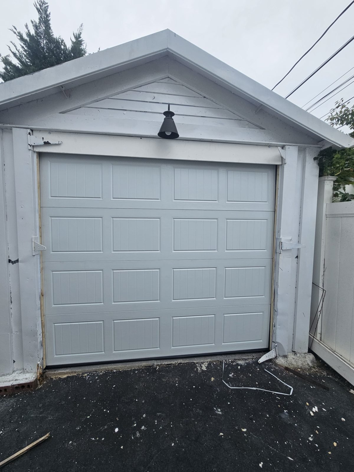 New white garage door installed on metal garage in Arlington, MA