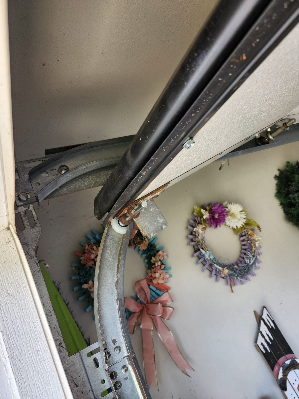 New garage door roller and bottom weather seal installed in Randolph, MA