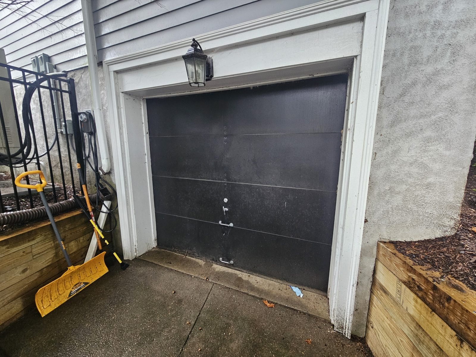 Garage door before replacement, door removed ahead of new installation