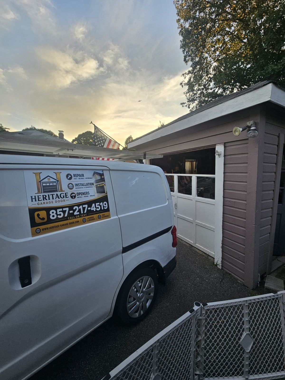 New white raised-panel garage door installed in the same opening